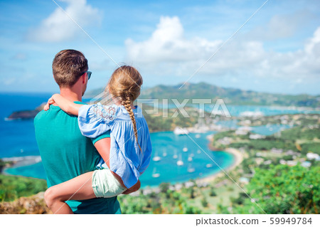 Family enjoying the view of picturesque English Harbour at Antigua in caribbean sea Family enjoying the view of picturesque English Harbour at Antigua in caribbean sea 59949784
