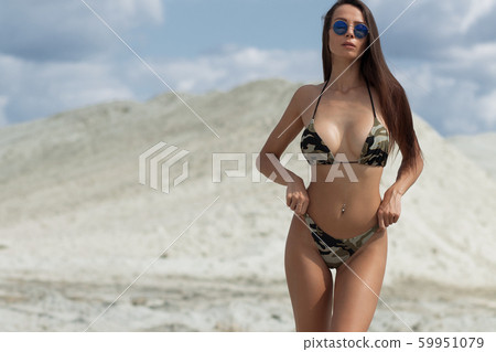 Beautiful woman in swimsuit on beach 59951079
