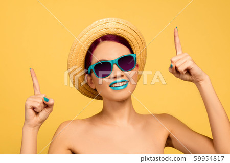 Portrait of beautiful young woman with bright make-up isolated on yellow studio background 59954817