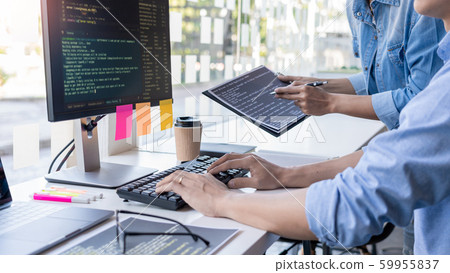 Pensive programmer working on on desktop pc 59955837