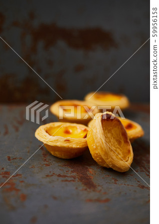 Egg tart dessert on the table. 59956158