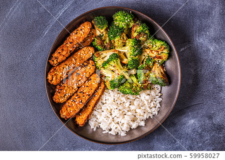 Fried tempeh with rice and broccoli. Fried tempeh with rice and broccoli. 59958027