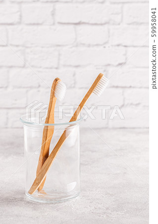 Eco-friendly toothbrushes in a glass. Eco-friendly toothbrushes in a glass. 59958041