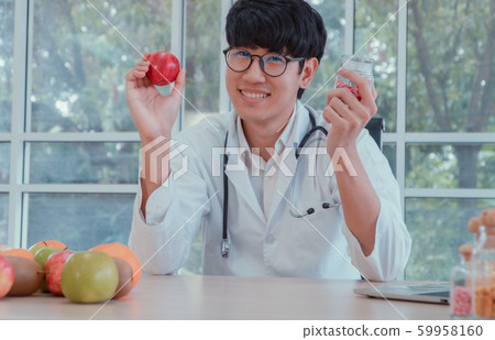 Doctors or nutritionists hold apples and Vitamin Doctors or nutritionists hold apples and Vitamin 59958160