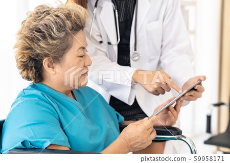 Doctor using tablet with old patient Doctor using tablet with old patient 59958171