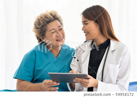 Doctor using tablet with old patient Doctor using tablet with old patient 59958172