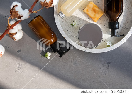Creams, shampoo and other hair and body care on the grey stone background with natural sunlight 59958861