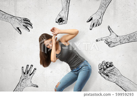 Young girl bending down covering her face with her hands trying to protect herself from mens' fists, finger guns and hands pointing at her. 59959293