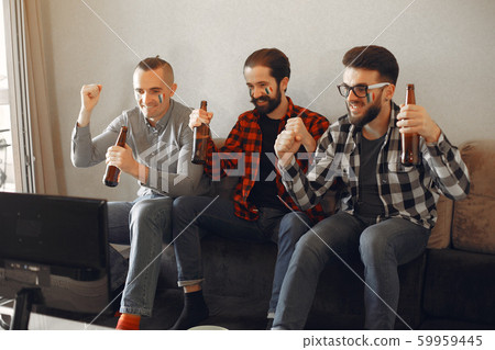 Group of fans are watching a soccer moment on the TV 59959445