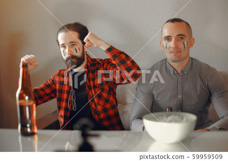 Group of fans are watching a soccer moment on the TV 59959509