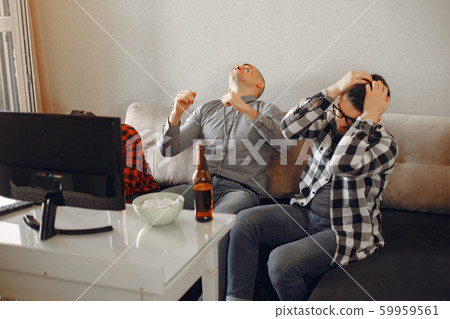 Group of fans are watching a soccer moment on the TV 59959561