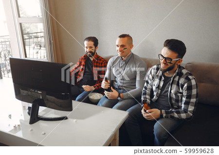 Group of fans are watching a soccer moment on the TV Group of fans are watching a soccer moment on the TV 59959628