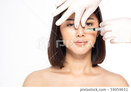 Asain young woman gets injection of botox in her Asain young woman gets injection of botox in her 59959631