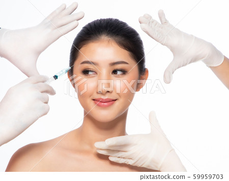Asian young woman gets injection  in her lips. 59959703