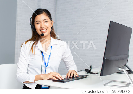 Charming all center agent smiling at camera in work space Charming all center agent smiling at camera in work space 59959820