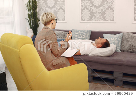Man sitting in the psychologist's office and talking about problems Man sitting in the psychologist's office and talking about problems 59960459