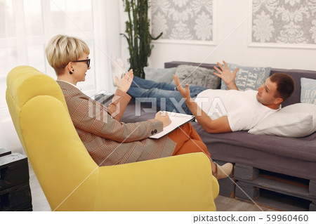 Man sitting in the psychologist's office and talking about problems Man sitting in the psychologist's office and talking about problems 59960460