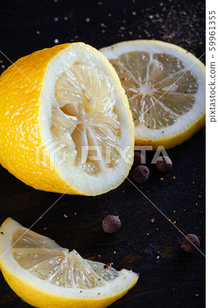Squeezed half of lemon, sliced wedges and black pepper. Squeezed half of lemon, sliced wedges and black pepper. 59961355