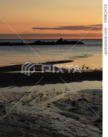 Bright orange morning sky over Lake Vanern. 59961419