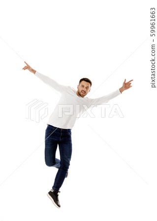 handsome young bearded man jumping 59961663