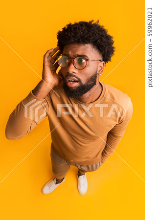 Top view of shocked black guy in glasses 59962021