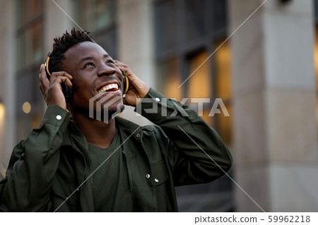 african-american man in wireless headphones listening music african-american man in wireless headphones listening music 59962218