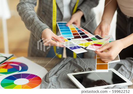 Fashion designer choosing color samples in atelier Fashion designer choosing color samples in atelier 59962252
