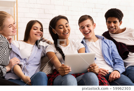 Diverse friends taking selfie with tablet pc Diverse friends taking selfie with tablet pc 59962303