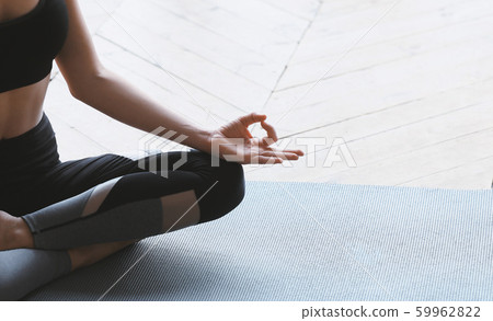 Yoga girl in lotus asana meditating at home 59962822