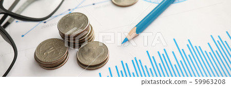 Pile of silver coins lying at financial chart document Pile of silver coins lying at financial chart document 59963208