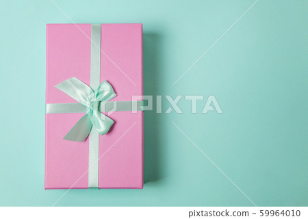 Pink gift box isolated on blue background 59964010