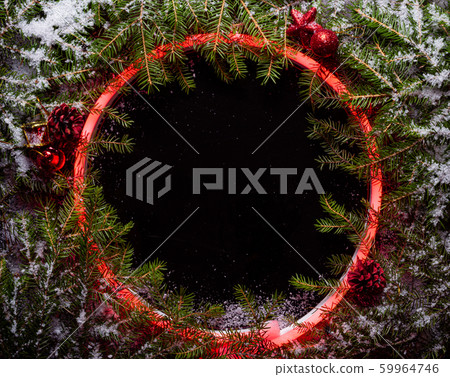 Christmas round frame made by neon and winter things on black background. 59964746
