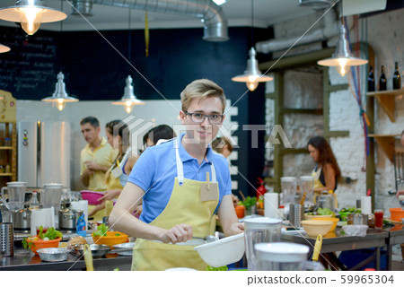 Cooking class. young happy friends in the kitchen Cooking class. young happy friends in the kitchen 59965304