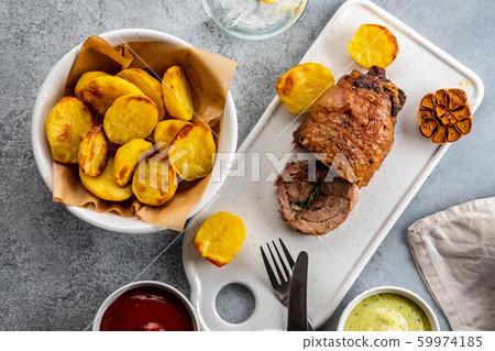 Meat with baked potatoes and sauces. top view. 59974185