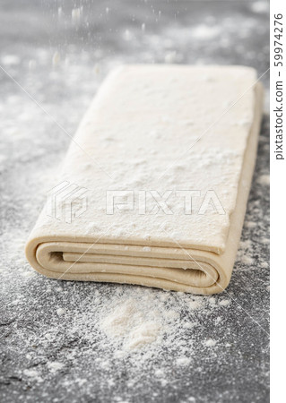 Fresh raw dough on table. Puff pastry. Copy space. Fresh raw dough on table. Puff pastry. Copy space. 59974276