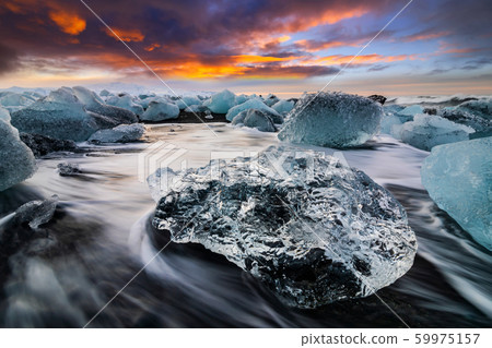 Ice rock with black sand beach at Jokulsarlon beach. Diamond beach in Iceland 59975157