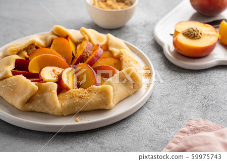 Appetite summer peach galeta on white table with copy space. summer open tart photo for cook book or food blog. 59975743