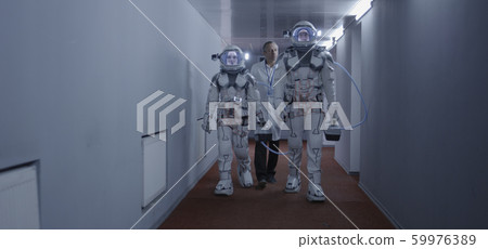 Astronauts walking down a corridor Astronauts walking down a corridor 59976389