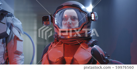 Female astronaut standing in corridor 59976560