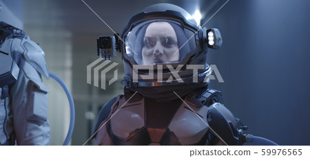 Female astronaut standing in corridor 59976565