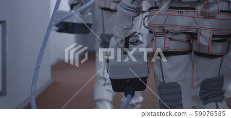 Astronauts carrying suitcases down a corridor 59976585