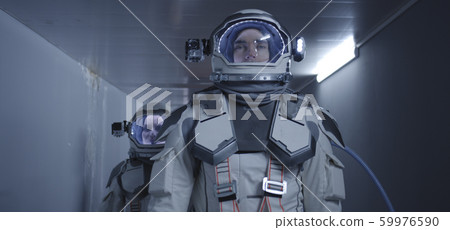 Astronauts walking down a corridor Astronauts walking down a corridor 59976590