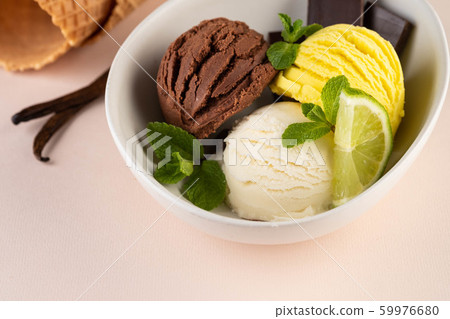 Trio of tasty chocolate vanilla and lime flavored frozen dessert in a white bowl. Trio of tasty chocolate vanilla and lime flavored frozen dessert in a white bowl. 59976680