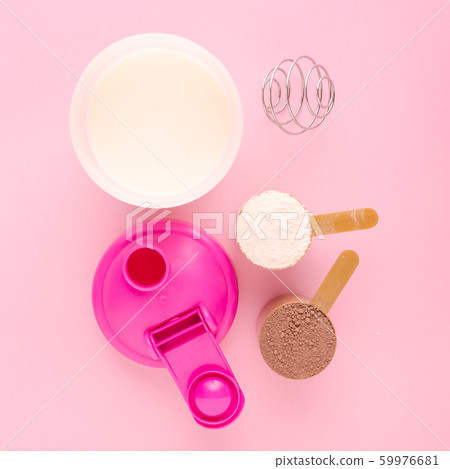 protein with a shaker and fresh milk on pink background protein with a shaker and fresh milk on pink background 59976681