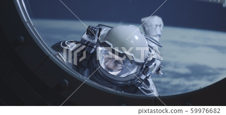 Astronaut floating by spacecrafts window Astronaut floating by spacecrafts window 59976682