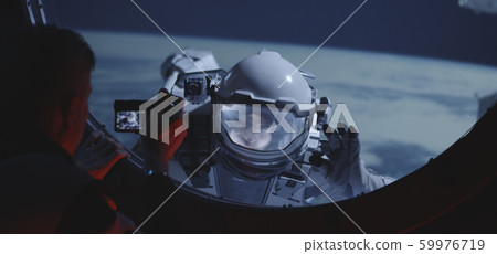 Astronaut filming spacewalking crewmate Astronaut filming spacewalking crewmate 59976719