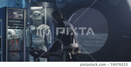 Astronaut exercising in a space station Astronaut exercising in a space station 59976810