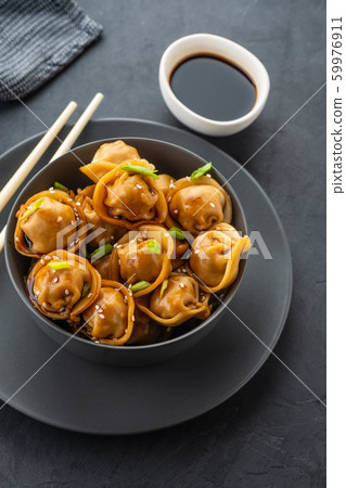 Asian dumplings in bowl, chopsticks, plates. Asian table setting. Chinese dumplings for dinner. Selective focus. Asian style decoration. Chinese fresh homemade food. Closeup Asian dumplings in bowl, chopsticks, plates. Asian table setting. Chinese dumplings for dinner. Selective focus. Asian style decoration. Chinese fresh homemade food. Closeup 59976911