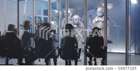 Astronaut matching palm with girl before departure 59977105