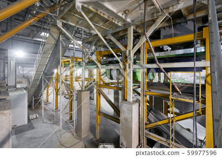 Large industrial mixer, for mixing ingredients into liquid cement.. Workers in the workshop of the Large industrial mixer, for mixing ingredients into liquid cement.. Workers in the workshop of the 59977596